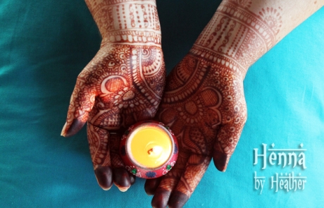 Indian Bridal / Karva Chauth Mehndi with diya on turquoise background