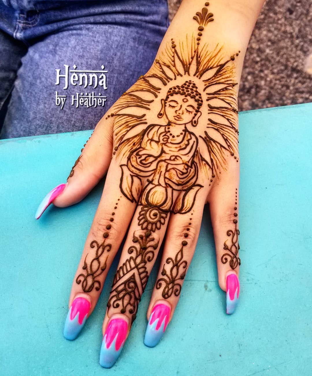 Buddha henna design on hand