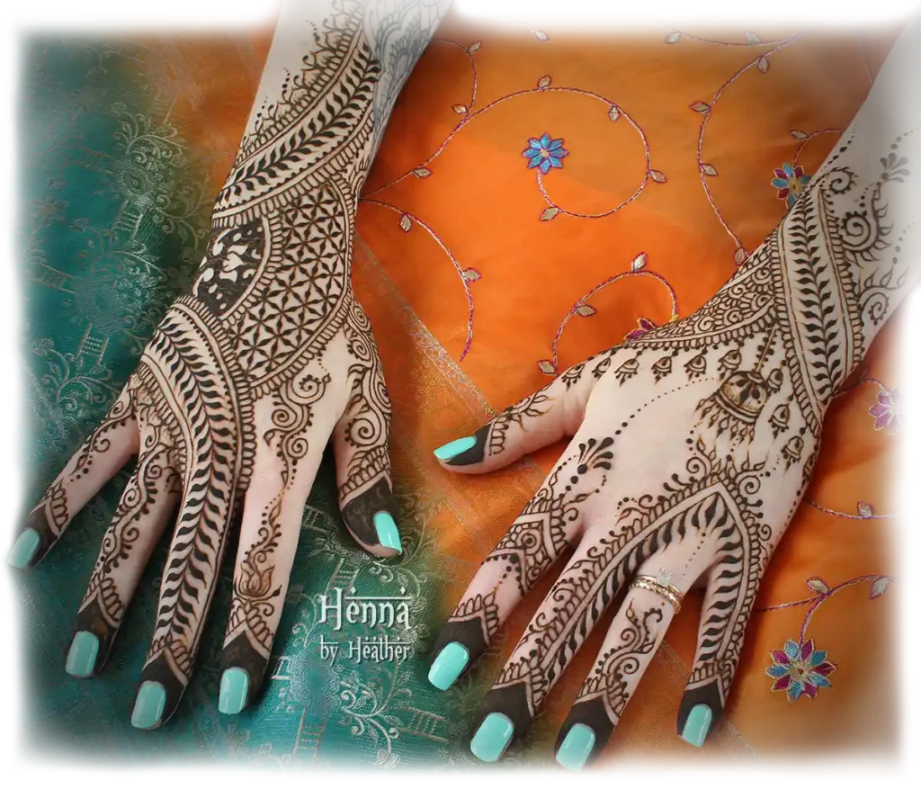 Intricate, modern Indian bridal mehndi with mini jhumkhas and seed of life grid. Henna is in the paste-on stage. Orange and turquoise sari fabric background in Henna by Heather brand colors. Turquoise fingernails. Artwork by Boston area bridal henna artist Heather Caunt-Nulton.